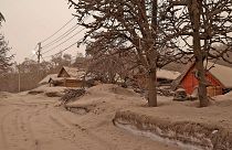 In this photo provided by the Russian Academy of Sciences' Volcanology Institute, volcanic ash covers the ground and houses after the Shiveluch volcano's eruption.