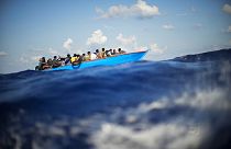 Migrants sail a wooden boat at south of the Italian Lampedusa island at the Mediterranean sea, Aug. 11, 2022.