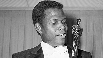 Sidney Poitier poses with his Oscar for best actor for "Lillies of the Field" at the 36th Annual Academy Awards in Santa Monica, Calif. on April 13, 1964.