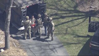 This image made from video provided by WCVB-TV, shows Jack Teixeira, in T-shirt and shorts, being taken into custody by armed tactical agents on Thursday, April 13, 2023,.