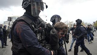 A protester is detained during a demonstration Thursday, April 13, 2023 in Paris.