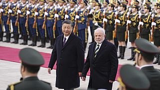 Brazilian President Luiz Inacio Lula da Silva, right, inspects an honor guard with Chinese President Xi Jinping.