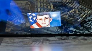 National guardsman Jack Teixeira, reflected in an image of the Pentagon in Washington.