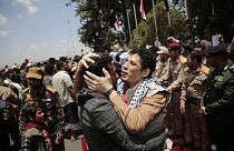 Houthi prisoners are greeted as they arrive to Sanaa airport.