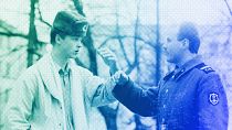 A soldier explains to a young man he would prefer to be a civilian during a street discussion in Vilnius, 26 March 1990