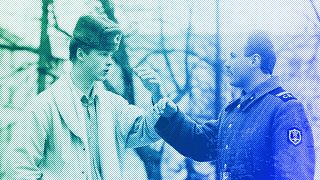 A soldier explains to a young man he would prefer to be a civilian during a street discussion in Vilnius, 26 March 1990