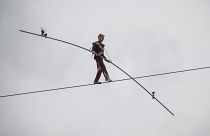 63-year-old circus artist Laszlo Simet walks on a tightrope across the two banks of the river Danube in downtown Budapest on Saturday, April 15, 2023.