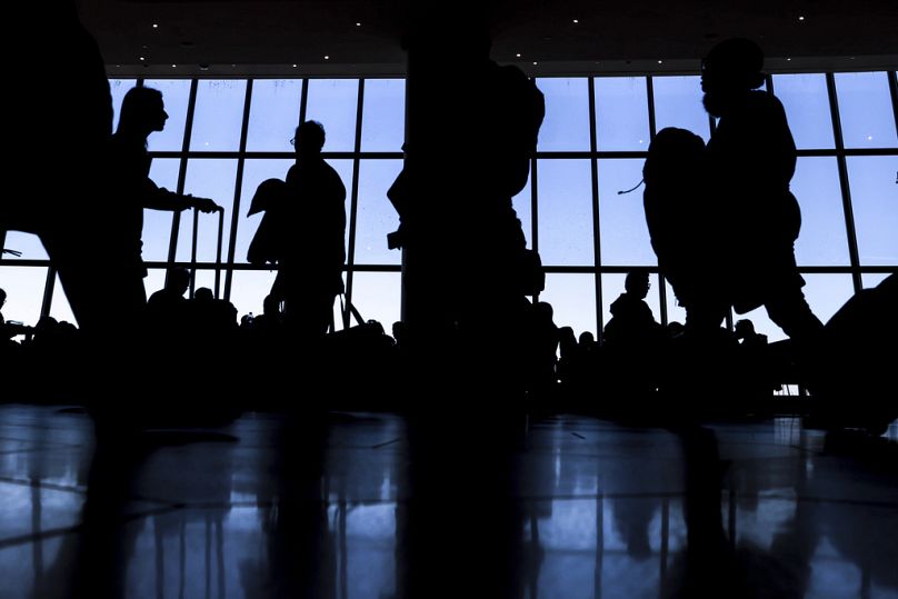 Travelers walk through LaGuardia Airport's Terminal B, New York, November 2022