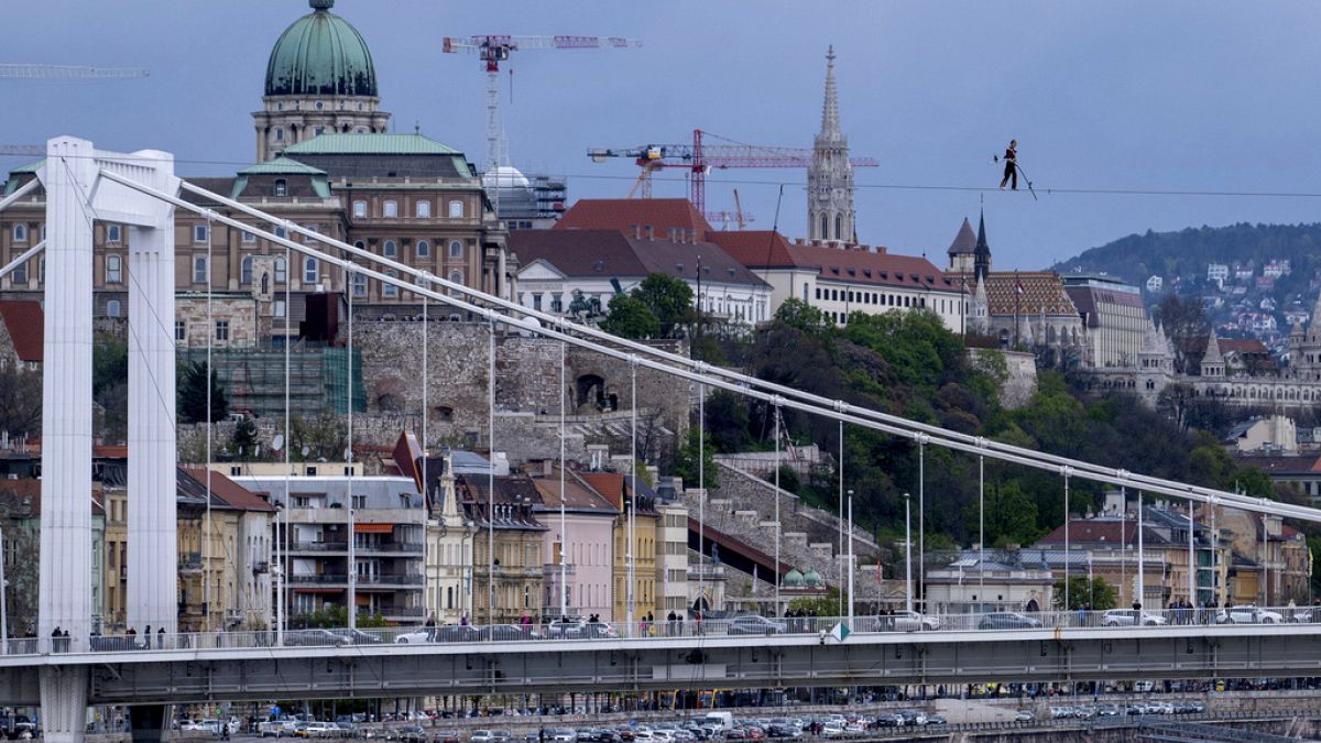 Hungarian acrobat Laszlo Simet walks on a rope across River Danube