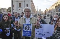 FILE - Pietro Orlandi wears a placard with a picture of his sister Emanuela during a sit-in near Saint Peter's Basilica, in Rome, Saturday, Jan. 14, 2023.