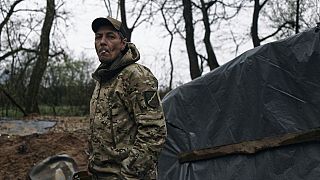 A Ukrainian soldier looks on at his position on the frontline in Bakhmut, Donetsk region, Ukraine, Thursday, April 13, 2023.