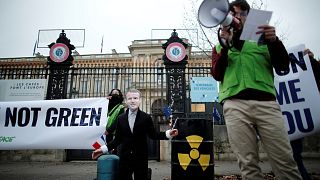 A Green activist attends a protest to denounce French push to include nuclear energy and fossil gas in the EU Green taxonomy.