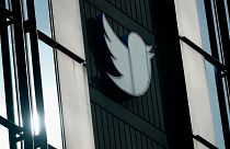 A Twitter logo hangs outside the company's offices in San Francisco, on Dec. 19, 2022.