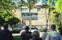 FILE: A man holds a sign reading "Putin Go Home" during a protest in front of the Russian Consulate in Mariehamn, Aland, Finland on June 1, 2022.