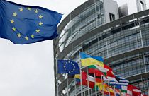The European flag, left, flies Tuesday, April 18, 2023 at the European Parliament in Strasbourg, eastern France.