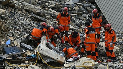 Rescue workers searching inside damaged container after landslide at Pakistan-Afghanistan border crossing on Tuesday.