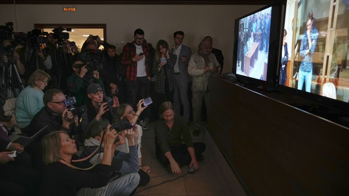 Journalists watch a TV screen broadcasting hearing on Wall Street Journal reporter Evan Gershkovich's case from a courtroom at the Moscow City Court, in Moscow, Russia.