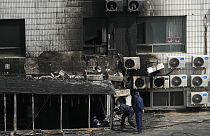 Investigators inspect burnt out corridor following a fire at a hospital in Beijing, Wednesday, April 19, 2023.