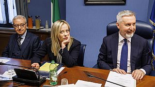 Italian Premier Giorgia Meloni, center, waits to start her briefing to COPASIR parliamentary intelligence commission in Rome.
