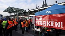 Railway workers protest in front of the Cologne Central Station during a nationwide strike.