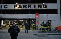 Members of the Fire Department of New York (FDNY) and New York Police Department (NYPD) work at the scene of a parking garage that collapsed in lower Manhattan, New York City,