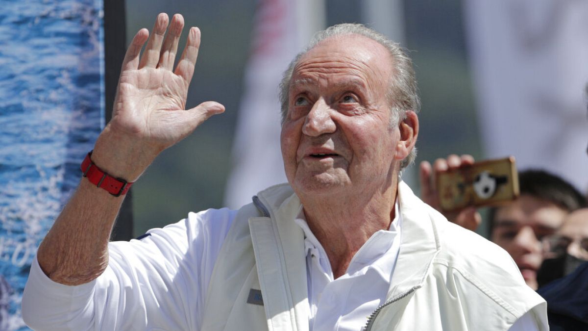 Spain's former King Juan Carlos waves before a reception at a nautical club prior to a yachting event in Sanxenxo, northwestern Spain, on, May 20, 2022.