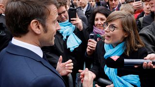 French President Emmanuel Macron argues with a person opposed to the pension reform, in Selestat, eastern France, Wednesday, April 19, 2023.