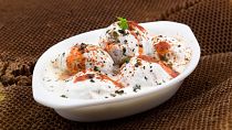 "Dahi Baray" (also called "Dahi Vada") or fried lentils in yoghurt