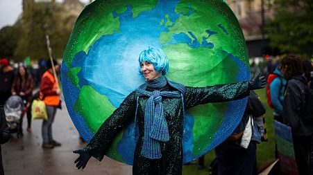A demonstrator wears a costume as people protest during the Extinction Rebellion's 'The Big One'