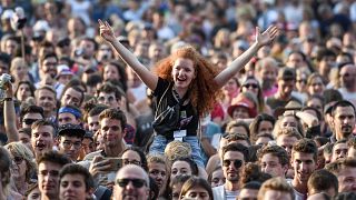 A festival goer waves during the concert of Icelandic blues/rock band Kaleo atthe 43rd Paleo music festival on July 17, 2087 in Nyon, western Switzerland.