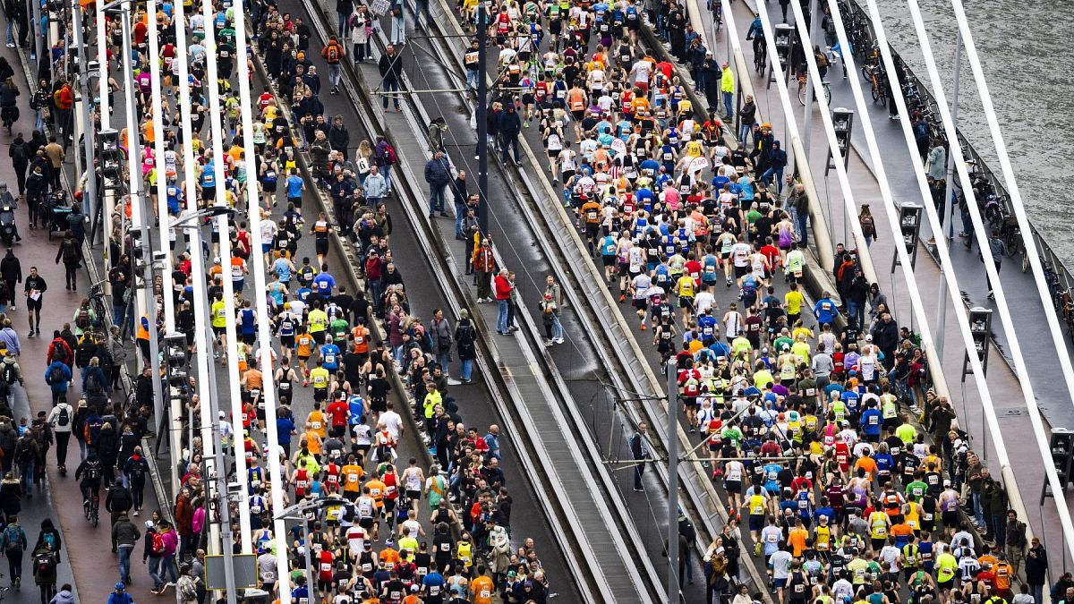Participants run across the Erasmus Bridge during the 42nd edition of the Rotterdam Marathon on April 16, 2023