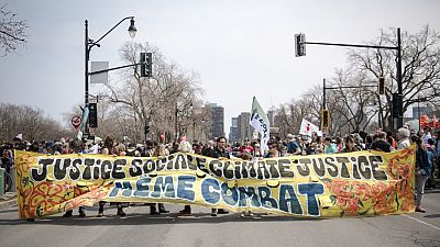 Climate activists hold out banner on their march on Montreal