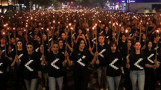 A torchlight procession marches during a demonstration in Yerevan, Armenia