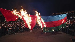 Demonstrators set representations of Turkish and Azerbaijani flags on fire in Yerevan, Armenia, Sunday, April 23, 2023