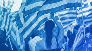 A supporter of the extreme far-right Golden Dawn political party waves a Greek flag during a pre-election rally, in Athens, September 2015