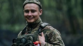 A Ukrainian soldier smiles on the frontline in Bakhmut, Donetsk region, Ukraine, Sunday, April 23, 2023. 