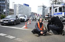 Police remove an activist from the road near Berlin's Ernst-Reuter-Platz central place. 