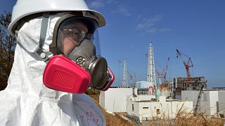 Мужчина в костюме химзащиты на АЭС "Фукусима-1"