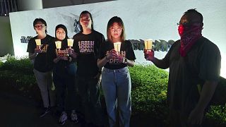 In this image taken and provided by Anti-Death Penalty Asia Network, members of Anti-Death Penalty Asia Network (ADPAN) hold candle outside Singapore Embassy in Kuala Lumpur.
