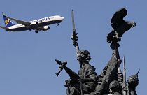 A Ryanair airplane approaching landing at Lisbon airport flies past the Monument to the Heroes of the Peninsular War, in the foreground, Aug. 21, 2019.