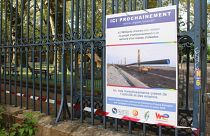 Sign announcing the false passage of an oil pipeline under a public park in Grenoble, France.