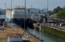 A ship is guided through the Panama Canal's Miraflores locks near Panama City.
