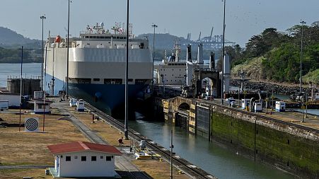 A ship is guided through the Panama Canal's Miraflores locks near Panama City.