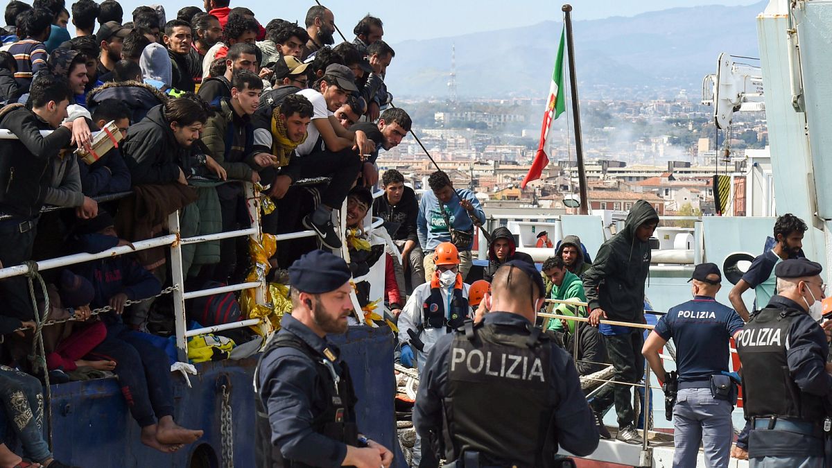 Migrants disembark from a ship in the Sicilian port of Catania, Wednesday, April 12, 2023