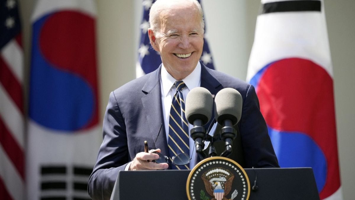 President Joe Biden takes his sunglasses off at a news conference with South Korea's President Yoon Suk Yeol in the Rose Garden of the White House.