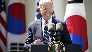 President Joe Biden takes his sunglasses off at a news conference with South Korea's President Yoon Suk Yeol in the Rose Garden of the White House.