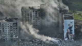 Smoke rises from a building in Bakhmut, the site of the heaviest battles with the Russian troops in the Donetsk region, Ukraine, Wednesday, April 26, 2023