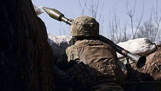 A Ukrainian soldier ires a grenade launcher on the frontline during a battle with Russian troops near Bakhmut, Donetsk region, Ukraine, Friday, March 24, 2023. 