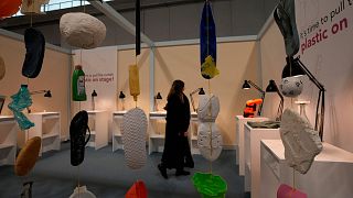 A woman looks at the 'Plastic on Stage' installation by Bozen's university at 2023's Milan Design Week