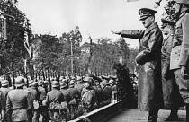 Adolf Hitler, front, salutes parading troops of the German Wehrmacht in Warsaw, Poland, on Oct. 5, 1939 after the German invasion. 